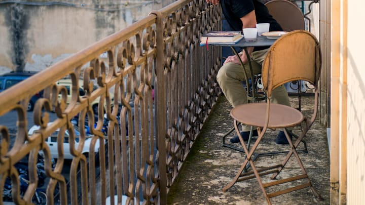 A guest on a private guestroom terrace at Seven Rooms... A guest on a private guestroom terrace at Seven Rooms...