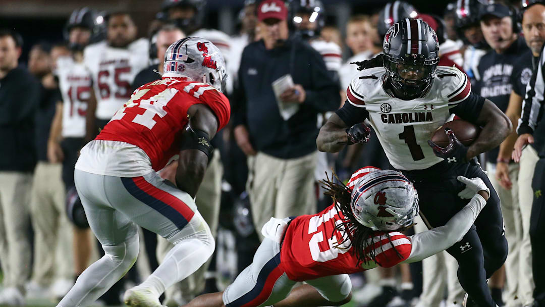 Nov 1, 2025; Oxford, Mississippi, USA; South Carolina Gamecocks running back Rahsul Faison (1) runs the ball as Mississippi Rebels defensive back Cedrick Beavers (13) attempts to make the tackle during the second quarter at Vaught-Hemingway Stadium. Mandatory Credit: Petre Thomas-Imagn Images