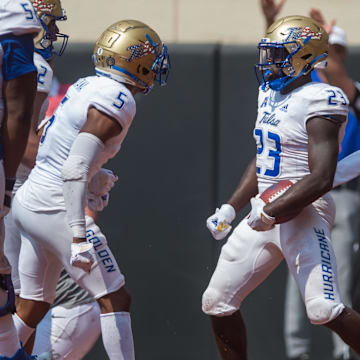 Sep 11, 2021; Stillwater, Oklahoma, USA;  Tulsa Golden Hurricane running back Anthony Watkins (23) celebrates with wide receiver JuanCarlos Santana (5) after his touchdown during the fourth quarter at Boone Pickens Stadium. The Cowboys won 28-23. Mandatory Credit: Brett Rojo-Imagn Images