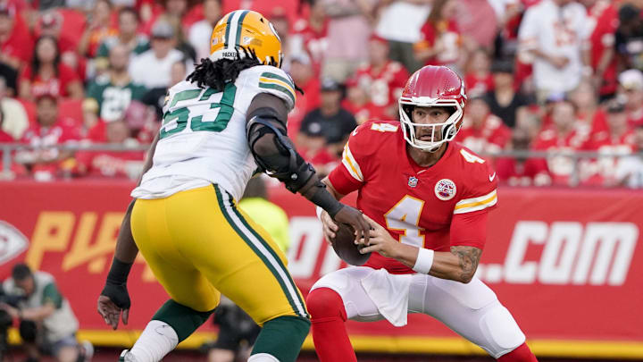 Aug 25, 2022; Kansas City, Missouri, USA; Kansas City Chiefs quarterback Chad Henne (4) scrambles as Green Bay Packers linebacker Jonathan Garvin (53) defends during the first half at GEHA Field at Arrowhead Stadium. Mandatory Credit: Denny Medley-Imagn Images