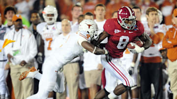 Jan 7, 2010; Pasadena, CA, USA; Alabama Crimson Tide wide receiver Julio Jones (8) is tackled by Texas Longhorns cornerback Aaron Williams (4) during the first quarter of the 2010 BCS national championship game at the Rose Bowl.  Mandatory Credit: Gary A. Vasquez-Imagn Images