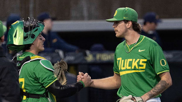 Oregon catcher Anson Aroz, left, congratulates pitcher Seth Mattox after the Ducks defeated the Toledo Rockets at PK Park in 