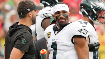 Philadelphia Eagles head coach Nick Sirianni speaks with quarterback Jalen Hurts (1) during the second quarter of the game against the Kansas City Chiefs at GEHA Field at Arrowhead Stadium.