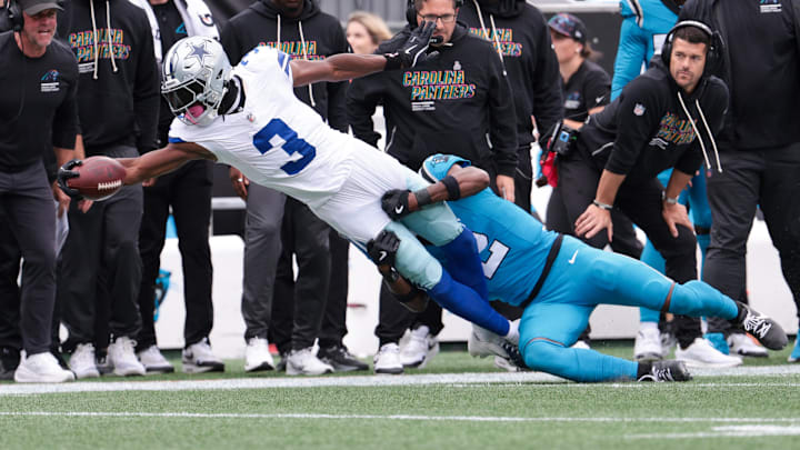 Dallas Cowboys wide receiver George Pickens reaches while Carolina Panthers cornerback Mike Jackson tackles. Dallas Cowboys wide receiver George Pickens reaches while Carolina Panthers cornerback Mike Jackson tackles.
