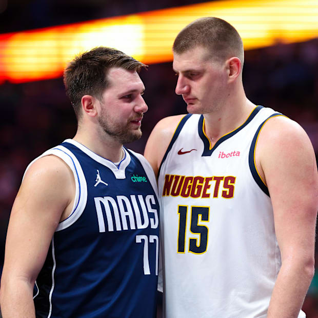 Dallas Mavericks guard Luka Doncic (77) speaks with Denver Nuggets center Nikola Jokic