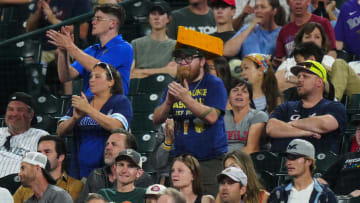 Jul 2, 2024; Denver, Colorado, USA; Milwaukee Brewers fans react to a score in the ninth inning against the Colorado Rockies at Coors Field. Mandatory Credit: Ron Chenoy-USA TODAY Sports