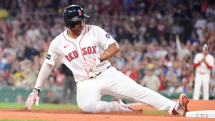 Jul 28, 2024; Boston, Massachusetts, USA; Boston Red Sox third baseman Rafael Devers (11) slides into third base during the fourth inning against the New York Yankees at Fenway Park. Mandatory Credit: Eric Canha-USA TODAY Sports