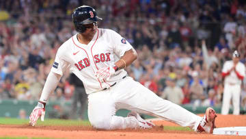 Boston Red Sox third baseman Rafael Devers slides into third base on Saturday against the New York Yankees.