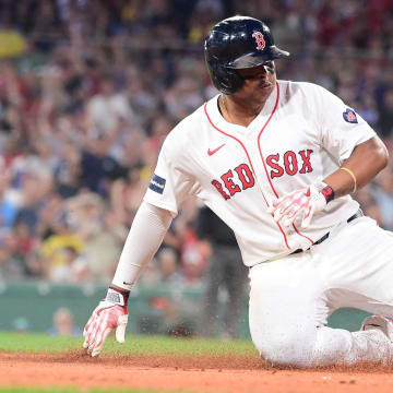 Boston Red Sox third baseman Rafael Devers slides into third base on Saturday against the New York Yankees.