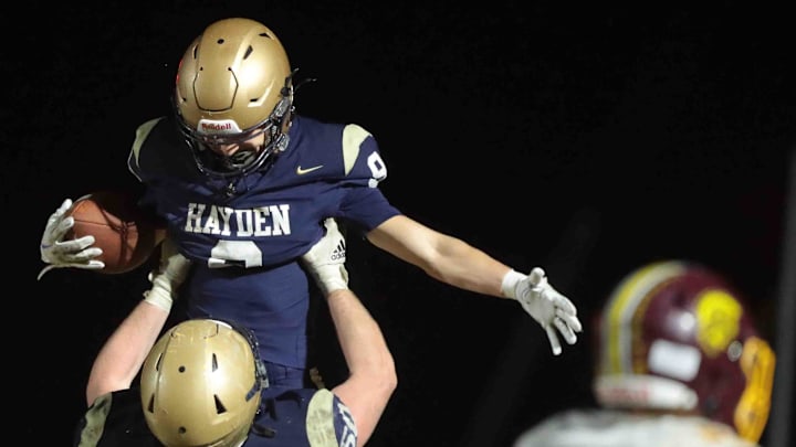 Hayden senior Jensen Schrickel is lifted after scoring a touchdown against Girard in the third quarter of the Class 3A Regional Championship game Friday, Nov. 8, 2024.