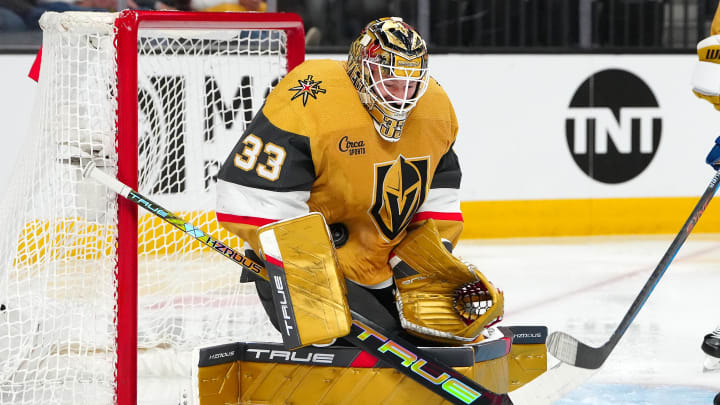 Apr 14, 2024; Las Vegas, Nevada, USA; Vegas Golden Knights goaltender Adin Hill (33) makes a save against the Colorado Avalanche during the second period at T-Mobile Arena. Mandatory Credit: Stephen R. Sylvanie-USA TODAY Sports