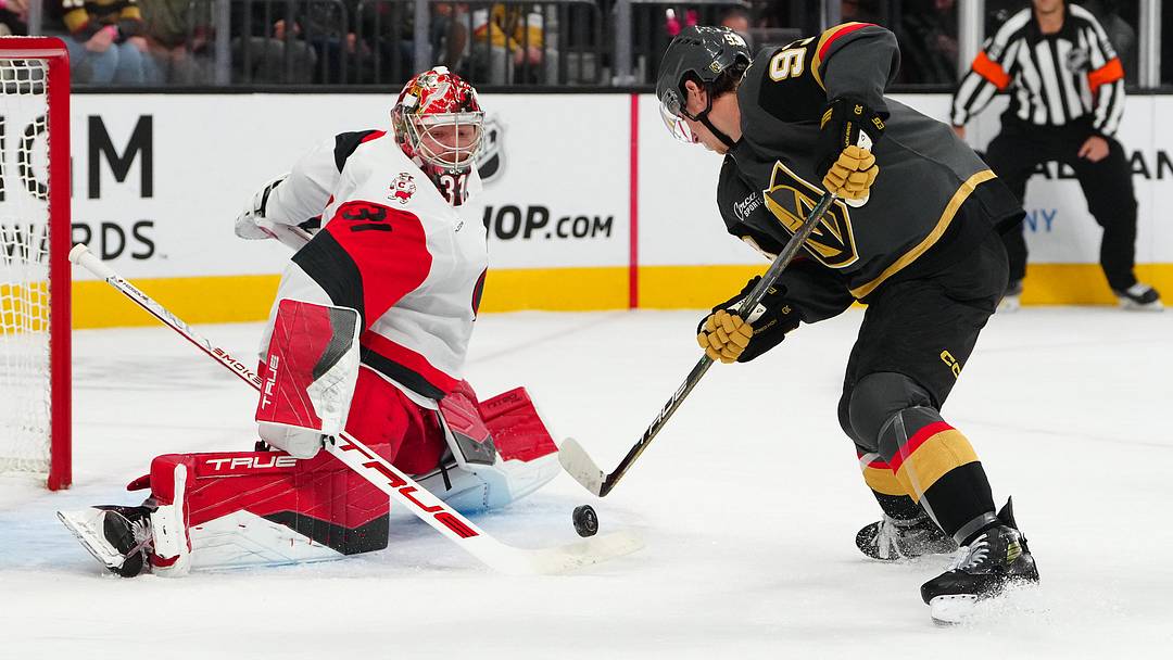 Oct 20, 2025; Las Vegas, Nevada, USA; Carolina Hurricanes goaltender Frederik Anderson (31) tips the puck away from Vegas Golden Knights right wing Mitch Marner (93) during the first period at T-Mobile Arena. Mandatory Credit: Stephen R. Sylvanie-Imagn Images
