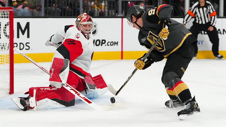 Oct 20, 2025; Las Vegas, Nevada, USA; Carolina Hurricanes goaltender Frederik Anderson (31) tips the puck away from Vegas Golden Knights right wing Mitch Marner (93) during the first period at T-Mobile Arena. Mandatory Credit: Stephen R. Sylvanie-Imagn Images