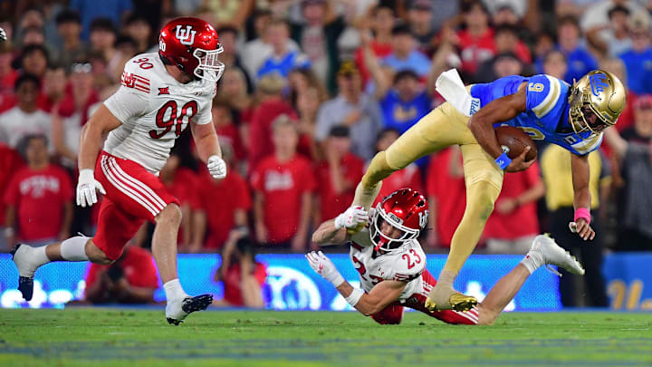 Aug 30, 2025; Pasadena, California, USA; Utah Utes defensive end John Henry Daley (90) and safety Jackson Bennee (23) move in against UCLA Bruins quarterback Nico Iamaleava (9) during the first half at Rose Bowl. Mandatory Credit: Gary A. Vasquez-Imagn Images