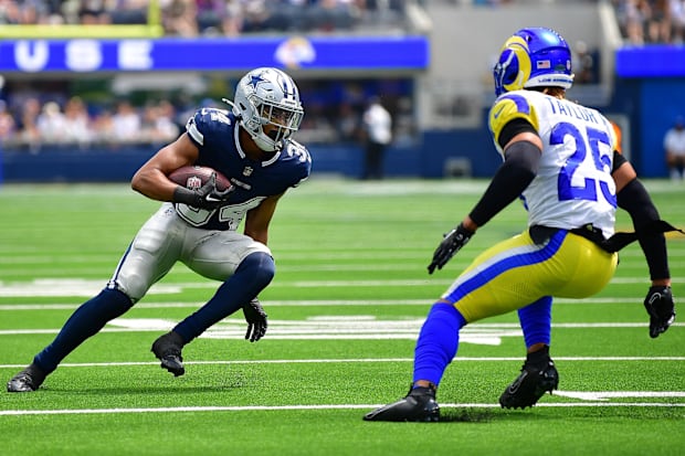 Dallas Cowboys running back Malik Davis runs the ball against Los Angeles Rams safety Jason Taylor II.