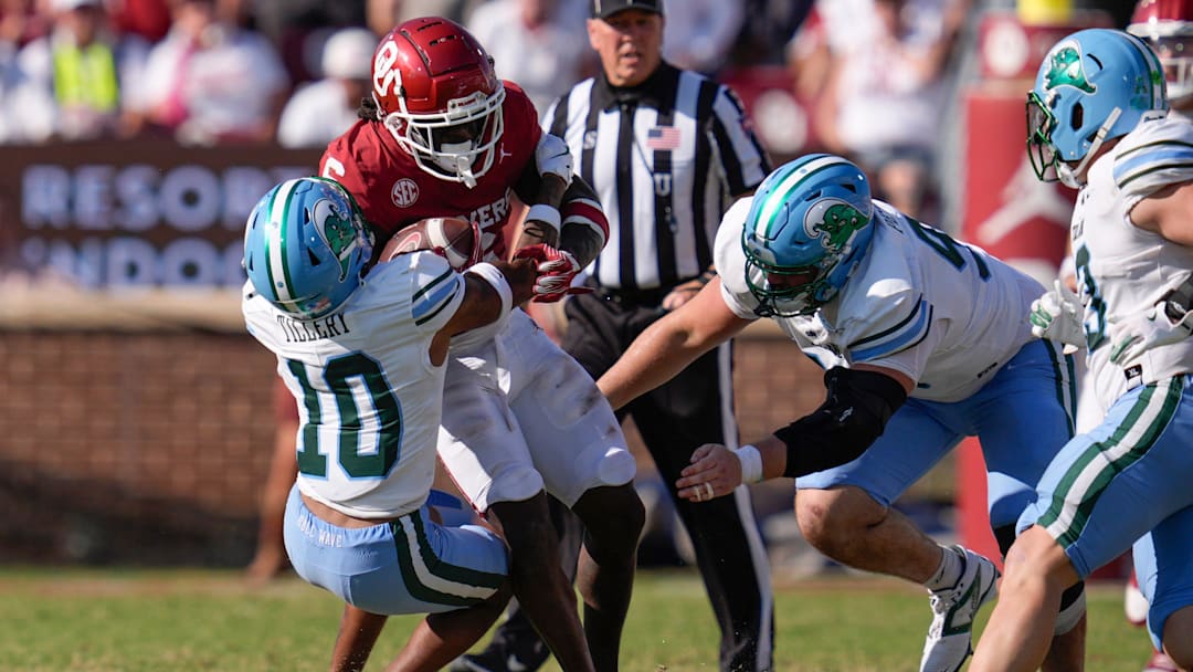 Oklahoma Sooners wide receiver Deion Burks (6) is brought down by Tulane Green Wave defensive back Lu Tillery (10) and Tulane Green Wave defensive end Parker Petersen (98) during a college football game between the University of Oklahoma Sooners (OU) and the Tulane Green Wave at Gaylord Family - Oklahoma Memorial Stadium in Norman, Okla., Saturday, Sept. 14, 2024. Oklahoma Sooners wide receiver Deion Burks (6) is brought down by Tulane Green Wave defensive back Lu Tillery (10) and Tulane Green Wave defensive end Parker Petersen (98) during a college football game between the University of Oklahoma Sooners (OU) and the Tulane Green Wave at Gaylord Family - Oklahoma Memorial Stadium in Norman, Okla., Saturday, Sept. 14, 2024.