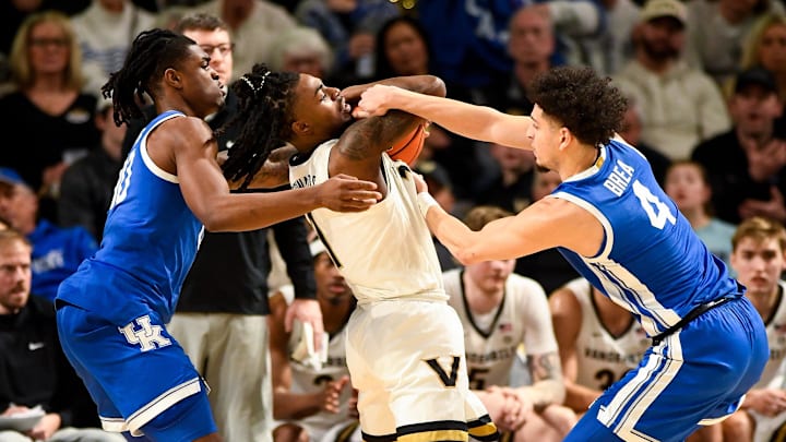Jan 25, 2025; Nashville, Tennessee, USA;  Kentucky Wildcats guard Koby Brea (4) traps Vanderbilt Commodores guard Jason Edwards (1) and get a jump ball called during the second half at Memorial Gymnasium. Mandatory Credit: Steve Roberts-Imagn Images