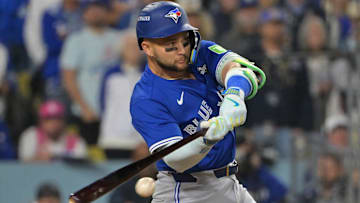 Oct 27, 2025; Los Angeles, California, USA; Toronto Blue Jays second baseman Bo Bichette (11) hits an RBI single against the Los Angeles Dodgers in the seventh inning during game three of the 2025 MLB World Series at Dodger Stadium. Mandatory Credit: Jayne Kamin-Oncea-Imagn Images
