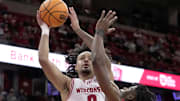 Wisconsin guard Braeden Carrington (0) scores on Ball State guard Elmore James (1) during the second half of their game Tuesday, November 11, 2025 at the Kohl Center in Madison, Wisconsin. Wisconsin beat Ball State 86-55.
