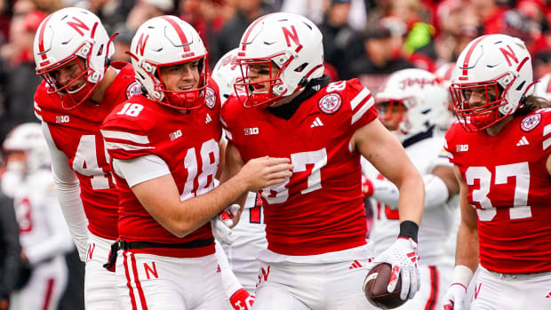 Nebraska Cornhuskers punter Brian Buschini (18) and tight end Nate Boerkircher (87) celebrate after a first down on a fake pu