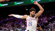 Nov 7, 2025; Sacramento, California, USA; Oklahoma City Thunder guard Ajay Mitchell (25) loses his footing after being fouled by Sacramento Kings guard Russell Westbrook (18) in the fourth quarter at the Golden 1 Center. Mandatory Credit: Cary Edmondson-Imagn Images