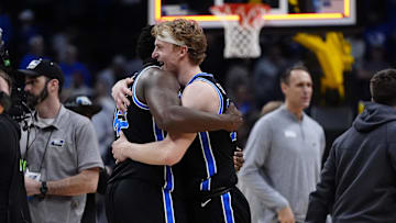 Mar 22, 2025; Denver, CO, USA; Brigham Young Cougars center Fousseyni Traore (45) and forward Richie Saunders (15)  react after defeating the Wisconsin Badgers in the second round of the NCAA Tournament  at Ball Arena. Mandatory Credit: Ron Chenoy-Imagn Images