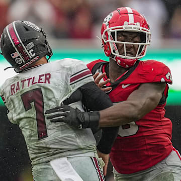 Sep 16, 2023; Athens, Georgia, USA; South Carolina Gamecocks quarterback Spencer Rattler (7) is hit by Georgia Bulldogs defensive lineman Mykel Williams (13) after throwing the ball during the second half at Sanford Stadium. Mandatory Credit: Dale Zanine-Imagn Images