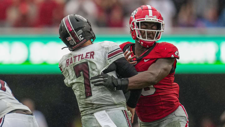 Sep 16, 2023; Athens, Georgia, USA; South Carolina Gamecocks quarterback Spencer Rattler (7) is hit by Georgia Bulldogs defensive lineman Mykel Williams (13) after throwing the ball during the second half at Sanford Stadium. Mandatory Credit: Dale Zanine-USA TODAY Sports