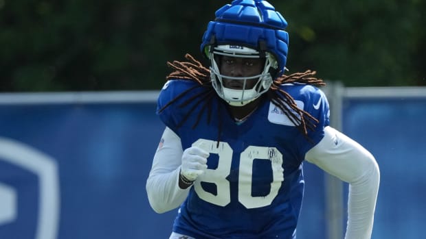 Indianapolis Colts tight end Jelani Woods (blue jersey with white sleeves) runs a route during training camp practice. 