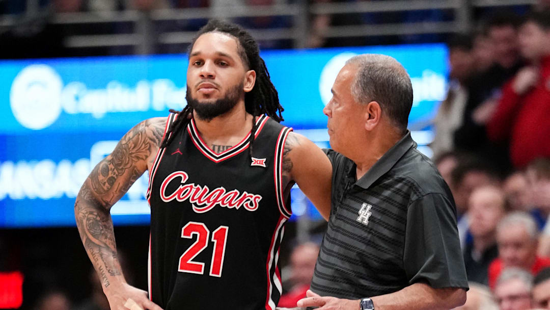 Feb 23, 2026; Lawrence, Kansas, USA; Houston Cougars head coach Kelvin Sampson talks with guard Emanuel Sharp (21) against the Kansas Jayhawks during the second half of the game at Allen Fieldhouse. 