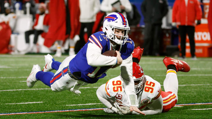 Buffalo Bills quarterback Josh Allen (17) dives for a first down ahead of Kansas City Chiefs defensive tackle Chris Jones (95).