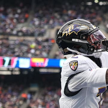 Dec 15, 2024; East Rutherford, New Jersey, USA; Baltimore Ravens wide receiver Rashod Bateman (7) catches a touchdown pass in front of New York Giants safety Dane Belton (24) during the first half at MetLife Stadium. Mandatory Credit: Vincent Carchietta-Imagn Images