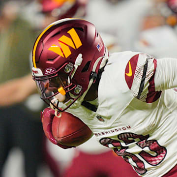 Kansas City Chiefs defensive back Kevin Knowles tackles Washington Commanders wide receiver Jaylin Lane.