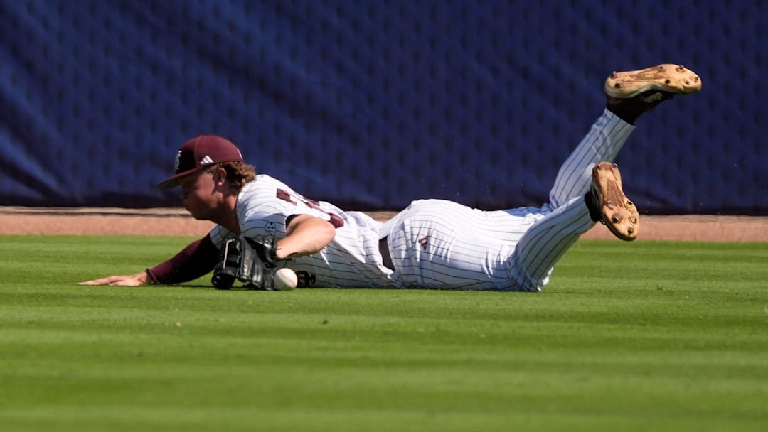 May 21, 2025; Hoover, AL, USA; Mississippi State left fielder Gehrig Frei (34) makes a diving try but can’t come up with a hit by a Texas A&M batter during a six-run second inning for the Aggies in the first round of the SEC Baseball Tournament at the Hoover Met.