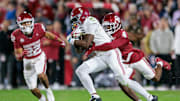 Nov 23, 2024; Norman, Oklahoma, USA; Alabama Crimson Tide wide receiver Germie Bernard (5) is tackled by Oklahoma Sooners defensive back Dez Malone (4) during the fourth quarter at Gaylord Family-Oklahoma Memorial Stadium. Mandatory Credit: William Purnell-Imagn Images