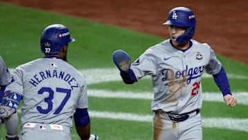 Oct 30, 2024; New York, New York, USA; Los Angeles Dodgers outfielder Tommy Edman (25) celebrates with outfielder Teoscar Hernandez (37) after scoring the go-ahead run during the eighth inning against the New York Yankees in game five of the 2024 MLB World Series at Yankee Stadium. Mandatory Credit: Wendell Cruz-Imagn Images