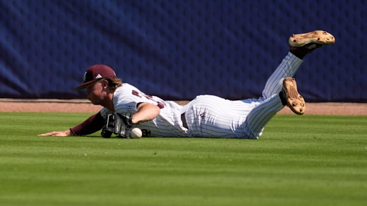 May 21, 2025; Hoover, AL, USA; Mississippi State left fielder Gehrig Frei (34) makes a diving try but can’t come up with a hit by a Texas A&M batter during a six-run second inning for the Aggies in the first round of the SEC Baseball Tournament at the Hoover Met.
