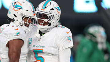 Jan 5, 2025; East Rutherford, New Jersey, USA; Miami Dolphins cornerback Jalen Ramsey (5) celebrates a defensive stop with linebacker Tyrel Dodson (11) during the first quarteragainst the New York Jets at MetLife Stadium. Mandatory Credit: Vincent Carchietta-Imagn Images