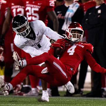 Cincinnati Bearcats cornerback Jordan Young (1) tackled Houston Cougars wide receiver Samuel Brown (4) in the fourth quarter of the NCAA football game between the Cincinnati Bearcats and the Houston Cougars TDECU Stadium in Houston, Texas, on Saturday, Nov. 11, 2023.