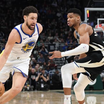 Jan 13, 2024; Milwaukee, Wisconsin, USA; Golden State Warriors guard Klay Thompson (11) drives against Milwaukee Bucks forward Giannis Antetokounmpo (34) in the first half at Fiserv Forum. Mandatory Credit: Michael McLoone-USA TODAY Sports