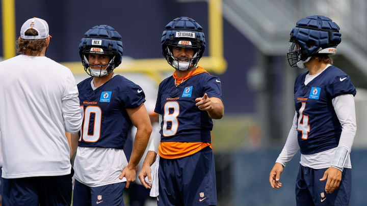 Jul 26, 2024; Englewood, CO, USA; Denver Broncos quarterback Jarrett Stidham (8) and quarterback Bo Nix (10) and quarterback Zach Wilson (4) during training camp at Broncos Park Powered by CommonSpirit. 