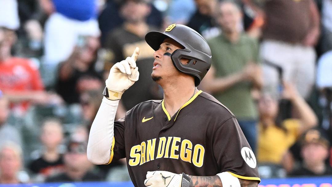 Jun 13, 2026; Baltimore, Maryland, USA;  San Diego Padres third baseman Manny Machado (13) hits a solo home run during the ninth inning against the Baltimore Orioles at Oriole Park at Camden Yards. Mandatory Credit: James A. Pittman-Imagn Images