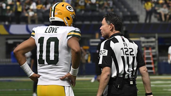 Oct 6, 2024; Inglewood, California, USA; Green Bay Packers quarterback Jordan Love (10) talks to referee Brad Allen before an NFL game against the Los Angeles Rams at SoFi Stadium. Mandatory Credit: Robert Hanashiro-Imagn Images