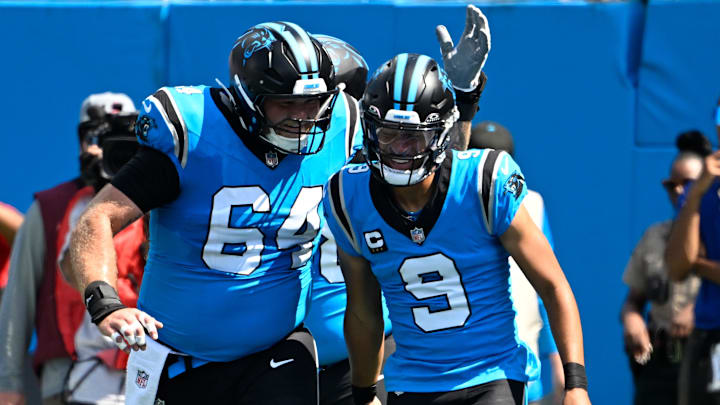 Sep 21, 2025; Charlotte, North Carolina, USA; Carolina Panthers quarterback Bryce Young (9) celebrates with center Cade Mays (64) after scoring a touchdown in the first quarter at Bank of America Stadium. Mandatory Credit: Bob Donnan-Imagn Images