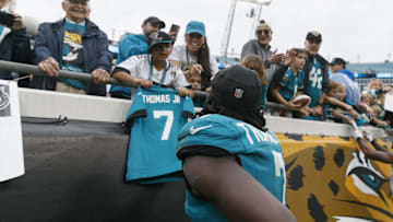 Dec 29, 2024; Jacksonville, Florida, USA; Jacksonville Jaguars wide receiver Brian Thomas Jr. (7) greets a young fan after the game against the Tennessee Titans  at EverBank Stadium. 