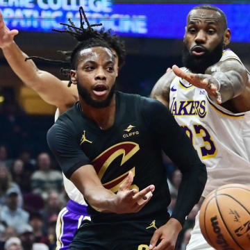 Nov 25, 2023; Cleveland, Ohio, USA; Cleveland Cavaliers guard Darius Garland (10) passes as Los Angeles Lakers forward LeBron James (23) defends during the first half at Rocket Mortgage FieldHouse. Mandatory Credit: Ken Blaze-USA TODAY Sports