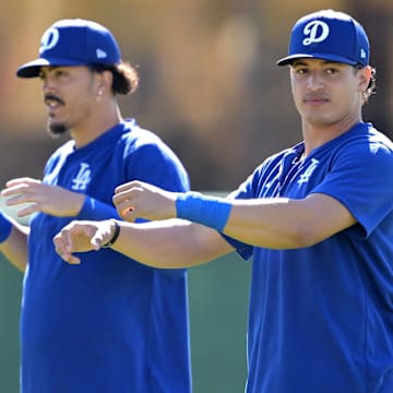 Feb 19, 2024; Glendale, AZ, USA; Los Angeles Dodgers second baseman Miguel Vargas (14) and catcher Diego Cartaya (76) stretch during spring training at Camelback Ranch. Mandatory Credit: Jayne Kamin-Oncea-Imagn Images