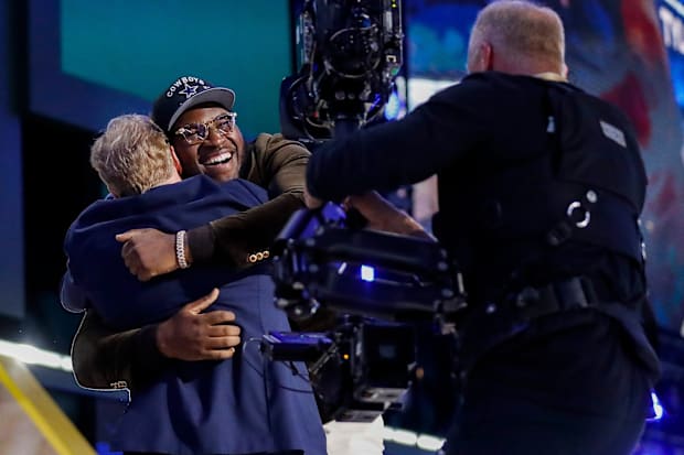 Tyler Booker embraces NFL Commissioner Roger Goodell after being selected 12th overall by the Dallas Cowboys in the NFL Draft