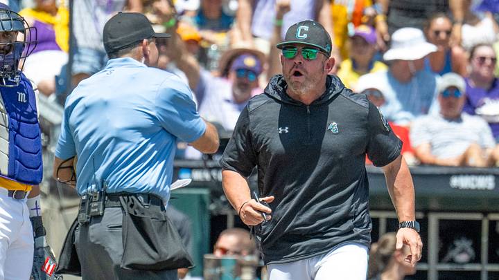 Jun 22, 2025; Omaha, Neb, USA;  Coastal Carolina Chanticleers head coach Kevin Schnall (9) gets thrown out of the game arguing with the umpires during the game against the LSU Tigers during the first inning at Charles Schwab Field. Mandatory Credit: Steven Branscombe-Imagn Images