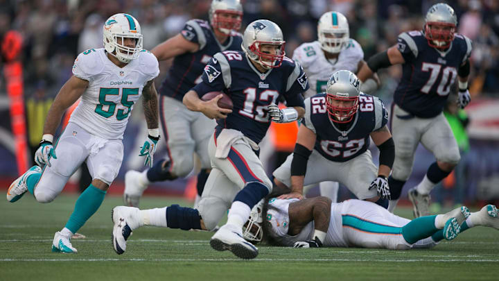 New England Patriots quarterback Tom Brady (12) runs for a first down on a fourth down play in the fourth quarter at Gillette Stadium in Foxboro, Massachusetts on October 27, 2013. (Allen Eyestone/The Palm Beach Post)

Miami Dolphins Vs New England Patriots